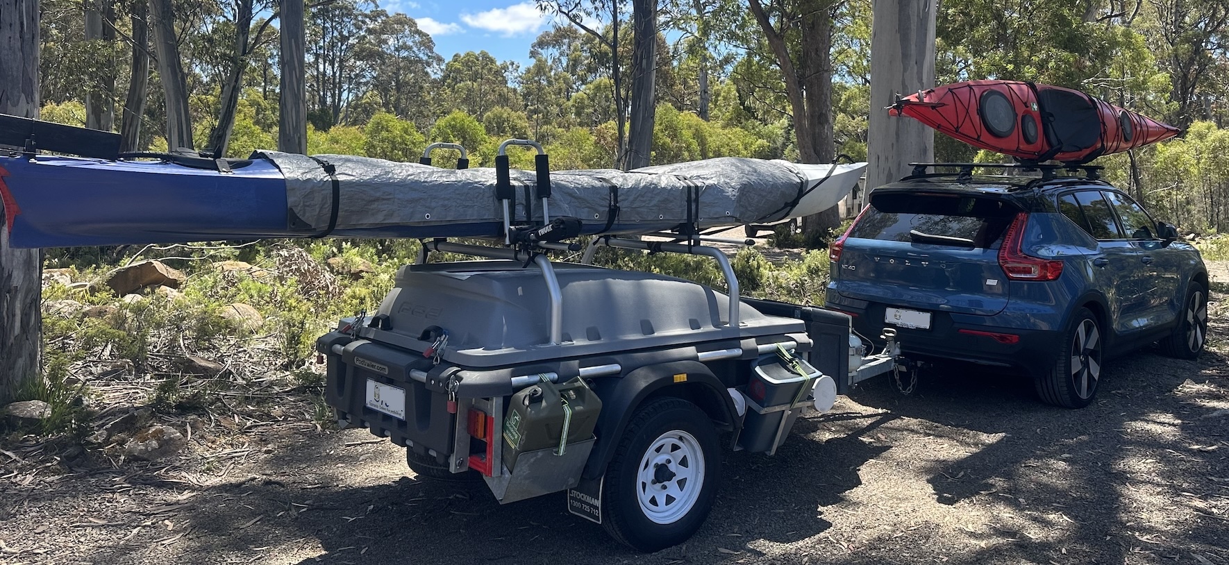 Image of Electric Vehicle (XC40) loaded with trailer, kayaks and camping gear on camping trip in Tasmania (2024)
